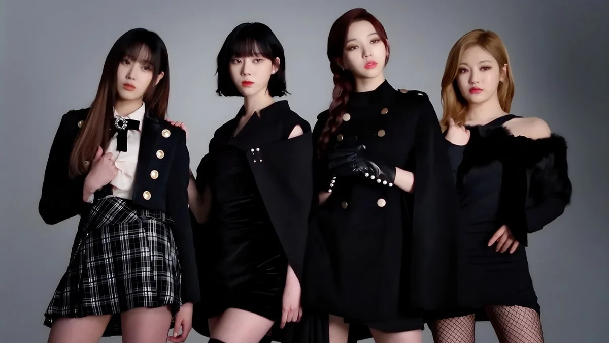 The four aespa members pose side by side in black outfits against a gray background.