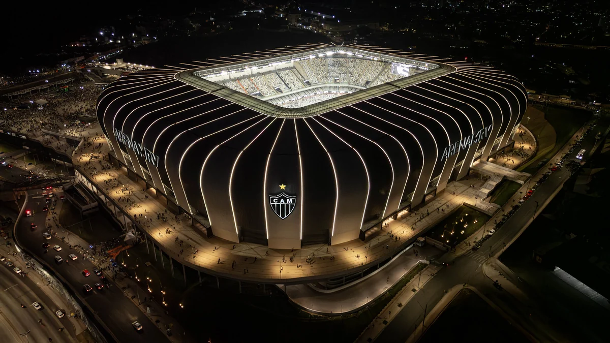 Arena MRV illuminated at night, seen from above with crowds around it