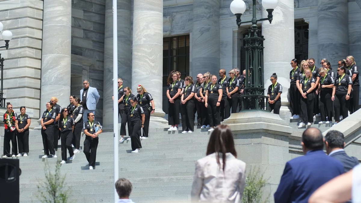 Black Ferns players gathered on the steps of a public building