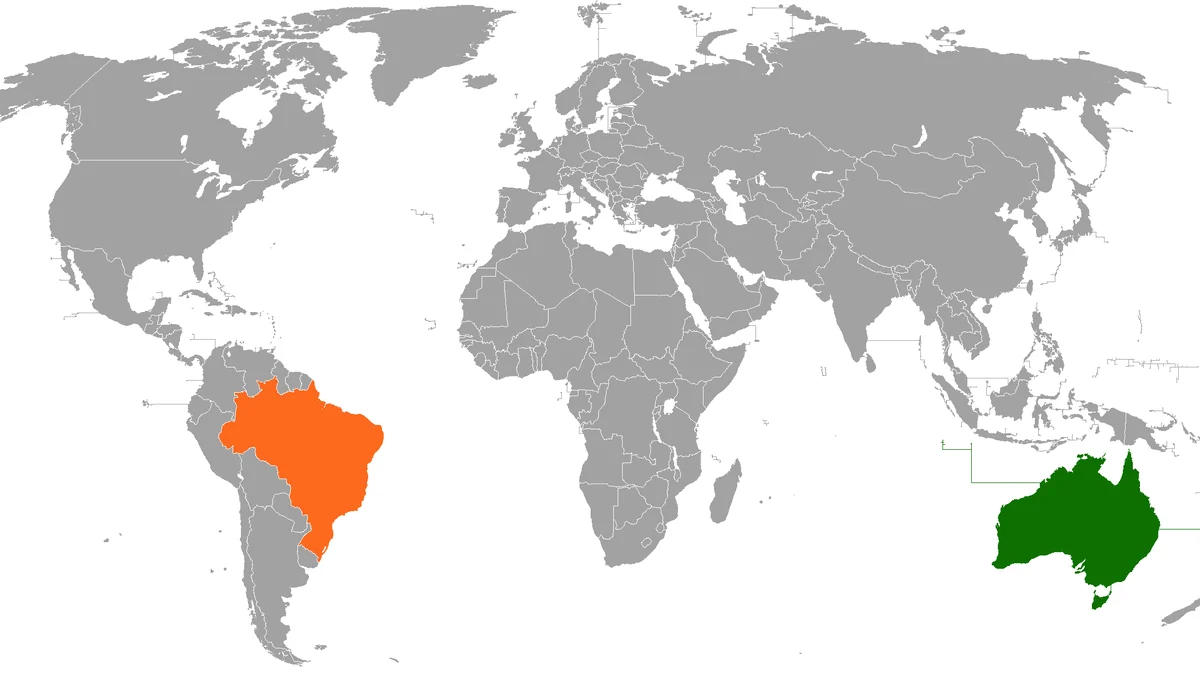 Mapa-múndi com o Brasil destacado em laranja e a Austrália em verde