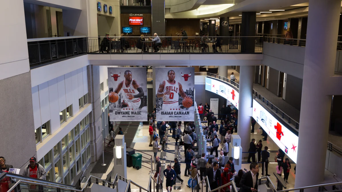United Center concourse with visitors and large posters of Chicago Bulls players
