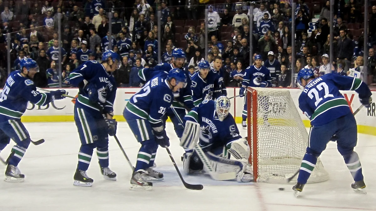 Vancouver Canucks players gathered around the net during warmups