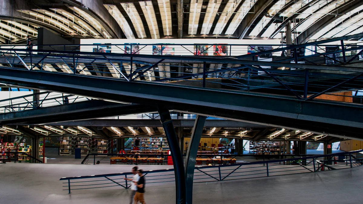 Wide CCSP interior with metal walkways, bookshelves and reading tables