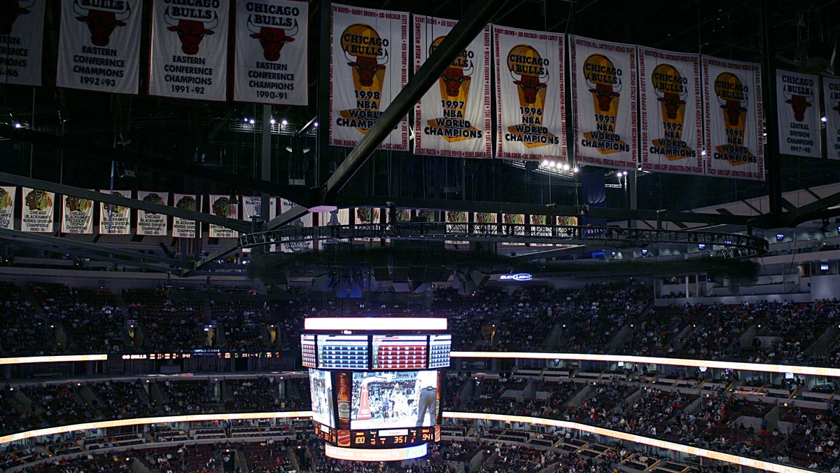 Chicago Bulls championship banners hanging above the United Center stands and scoreboard