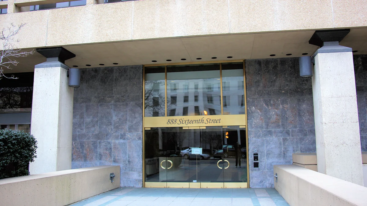 Glass entrance between concrete columns bearing the words 888 Sixteenth Street