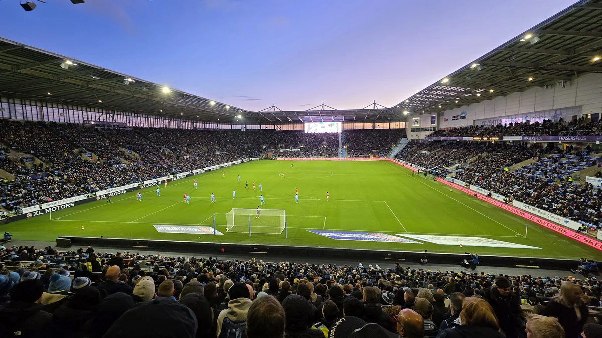 Wide view of the pitch and crowded stands inside the Coventry Building Society Arena