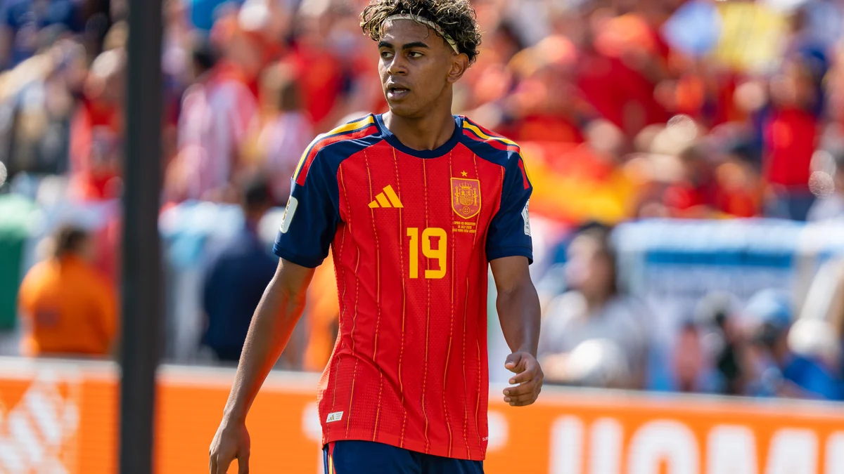 Lamine Yamal walks on the field wearing Spain’s red number 19 shirt