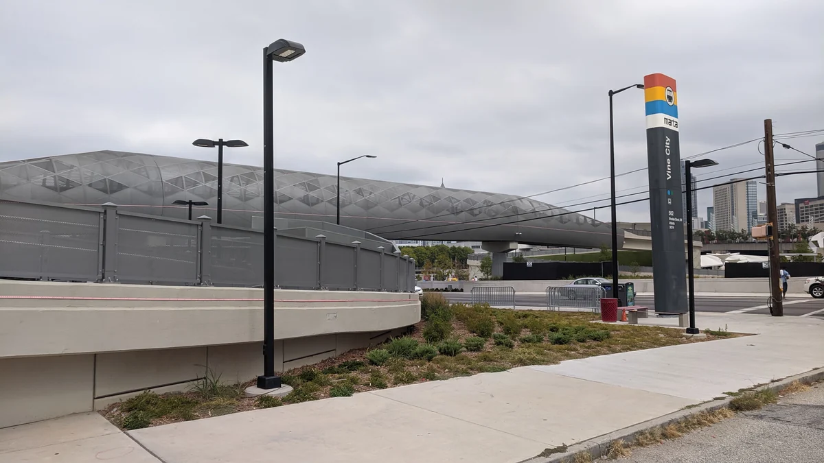 Silver-structured stadium seen behind Vine City station in Atlanta.