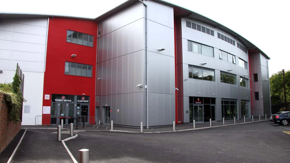 Gray and red Fleetwood Town building with ticket office and club shop