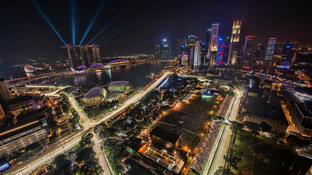 Illuminated Singapore night-race circuit in front of the Marina Bay skyline