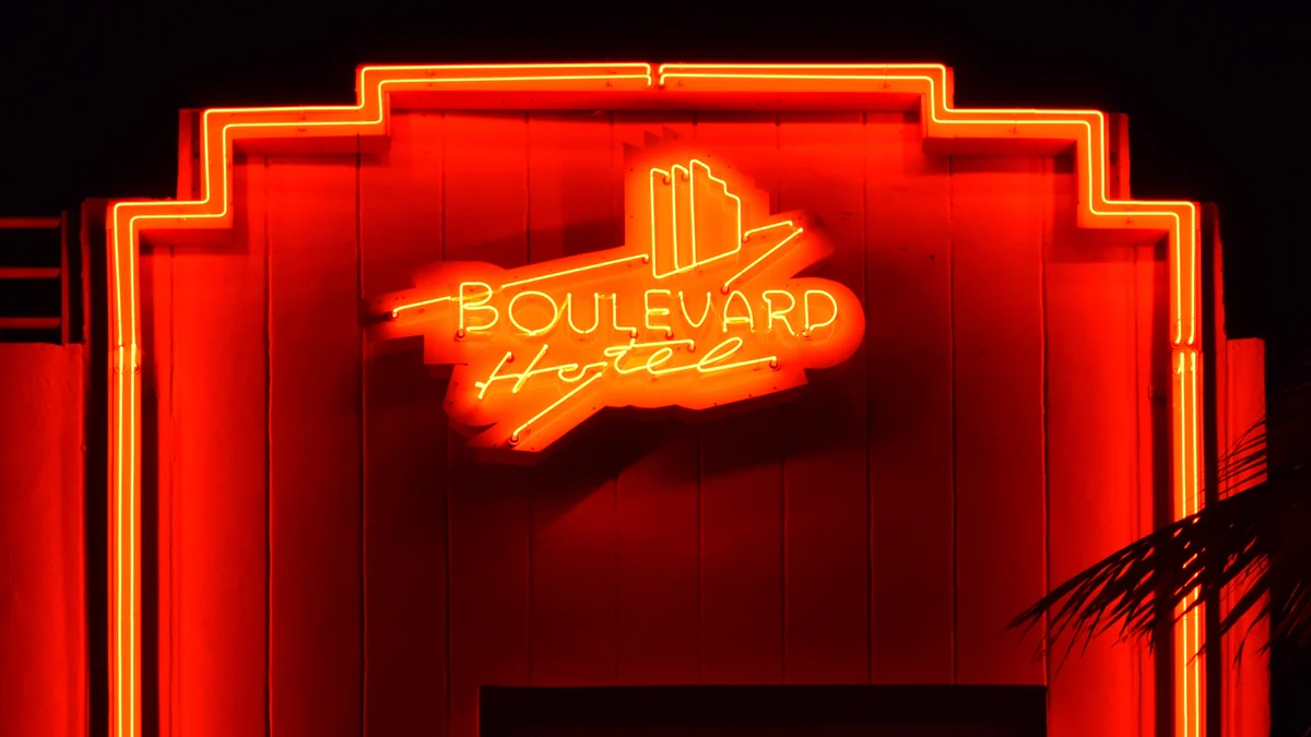 Red Boulevard Hotel neon sign at night