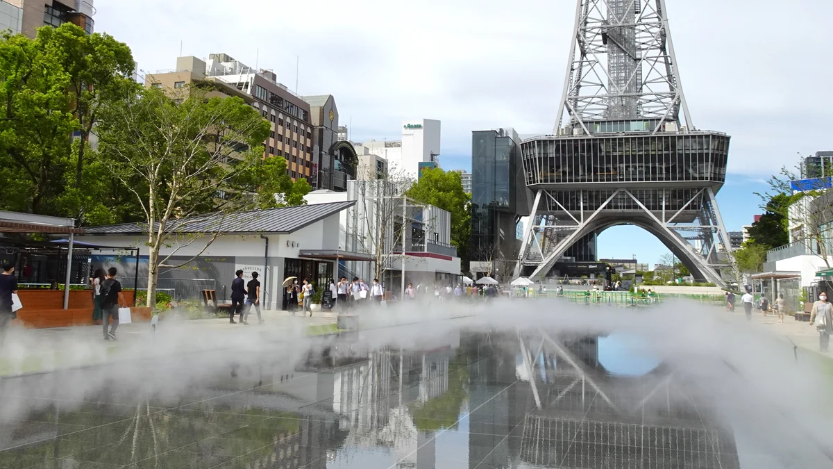 Pedestrian area with decorative mist and the tower’s metal structure in Hisaya-odori Park