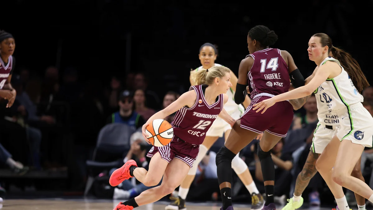 Toronto Tempo number 12 dribbles the ball as number 14 sets a screen in front of an opposing player.