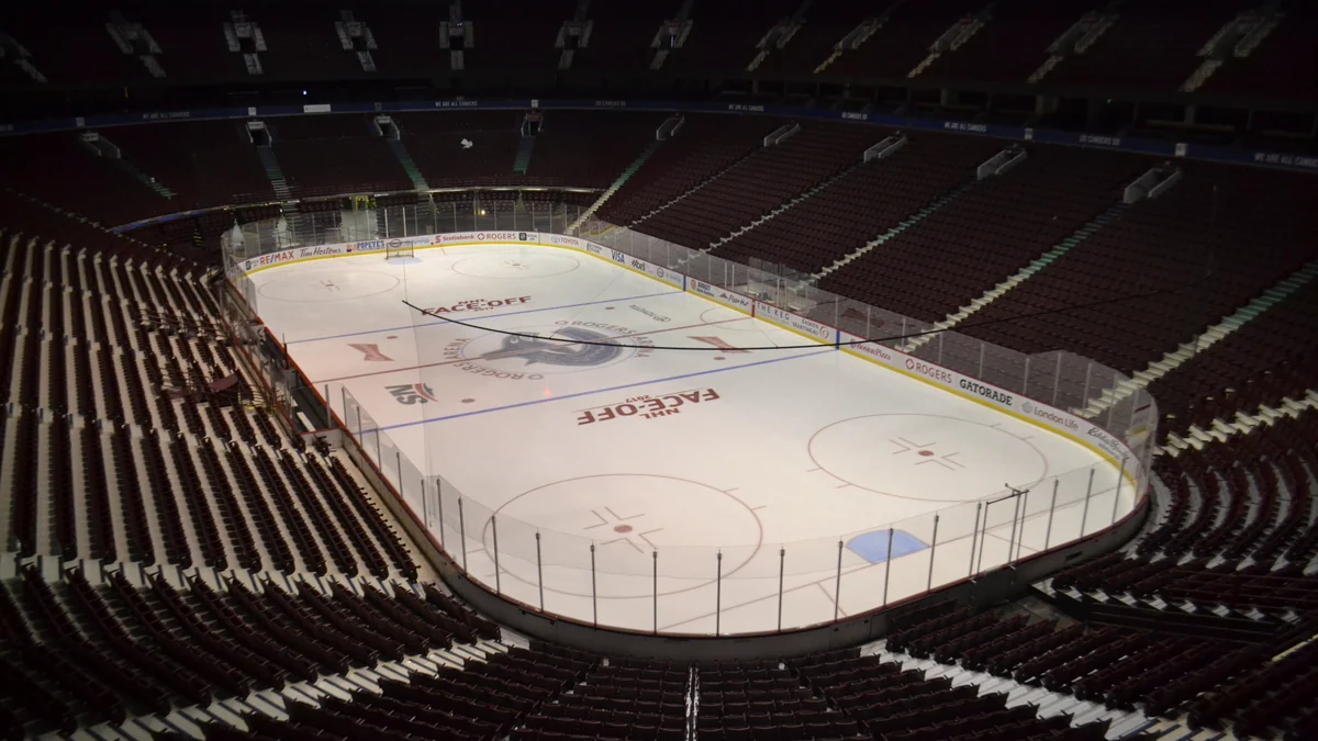 Empty hockey rink surrounded by seating inside Rogers Arena
