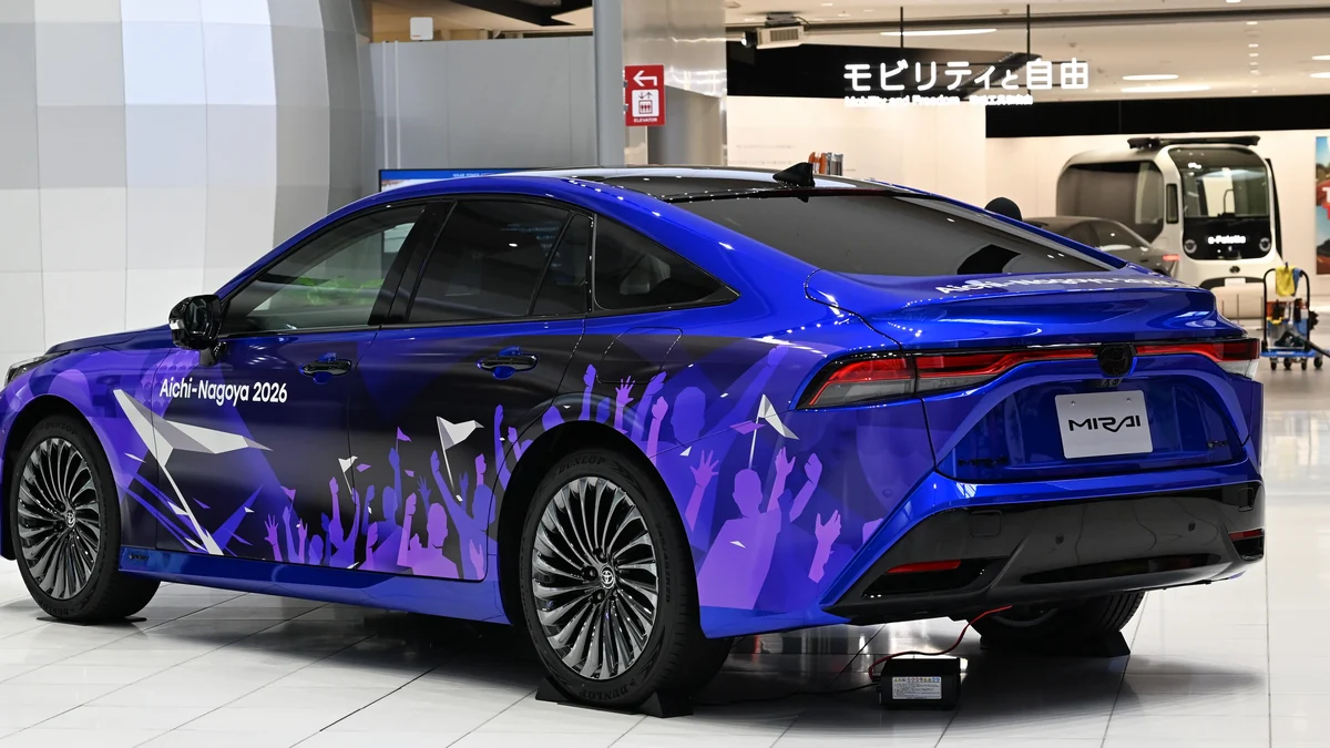 Rear view of a blue car with Aichi-Nagoya 2026 graphics