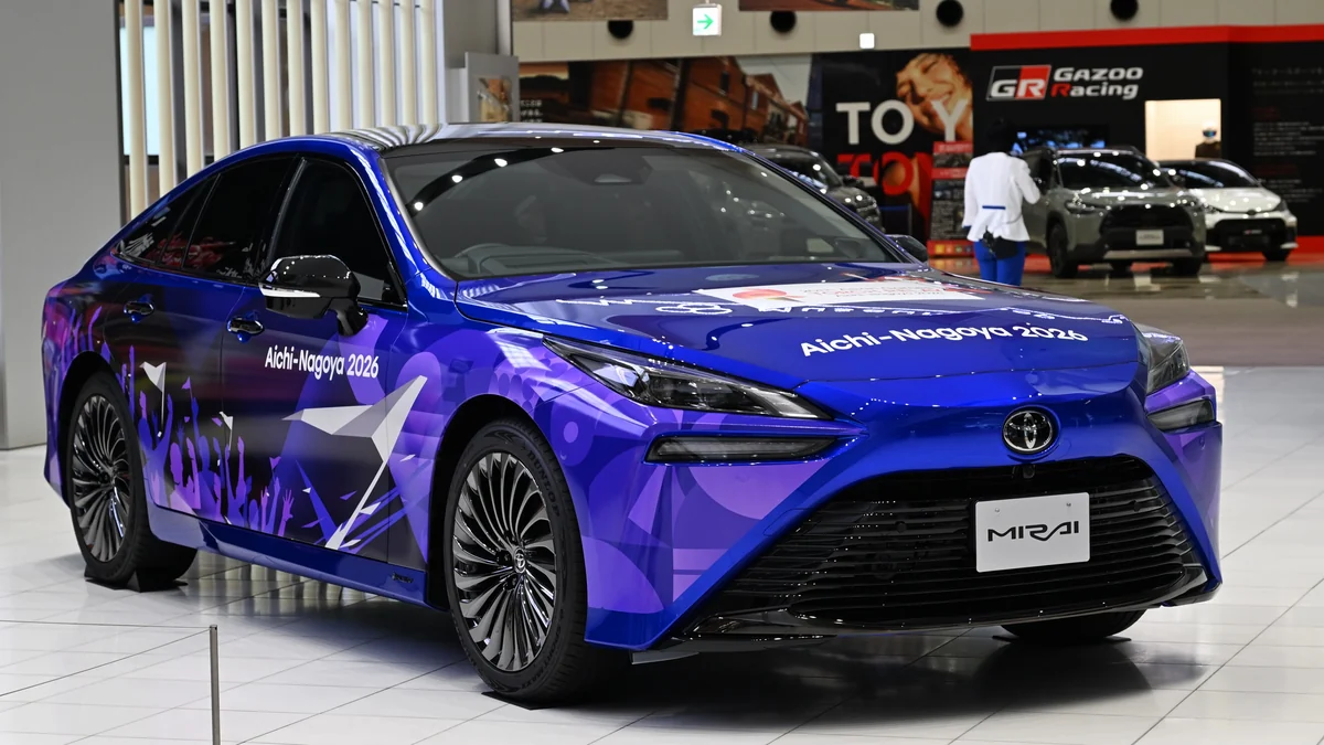 Blue car with purple graphics and Aichi-Nagoya 2026 lettering on display