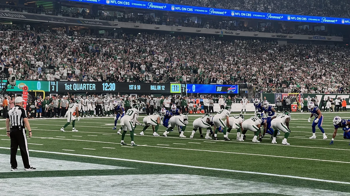 Buffalo Bills and New York Jets players lined up on the field at MetLife Stadium