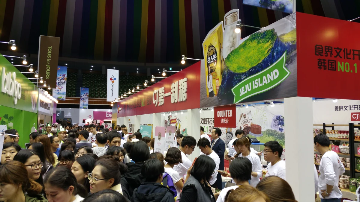 Visitors move among food and culture booths at the KCON Jeju 2015 convention