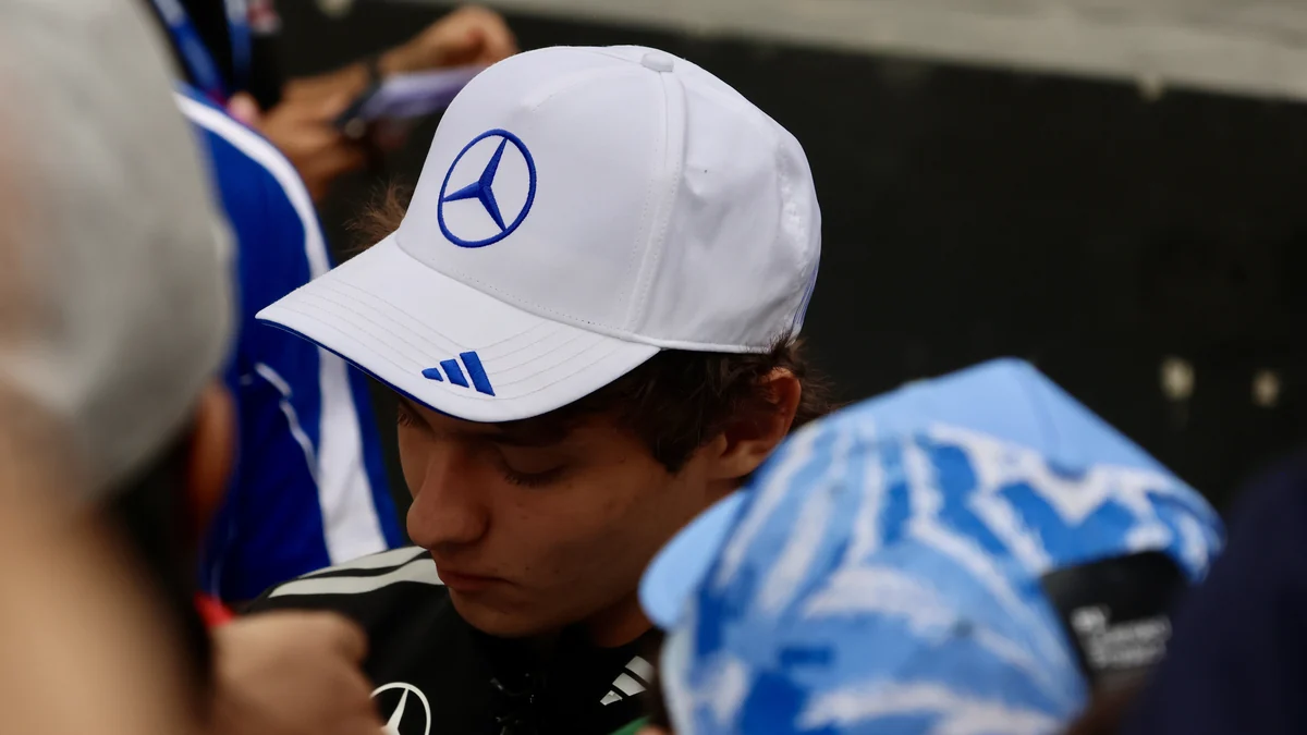 Kimi Antonelli wears a white Mercedes cap among a crowd