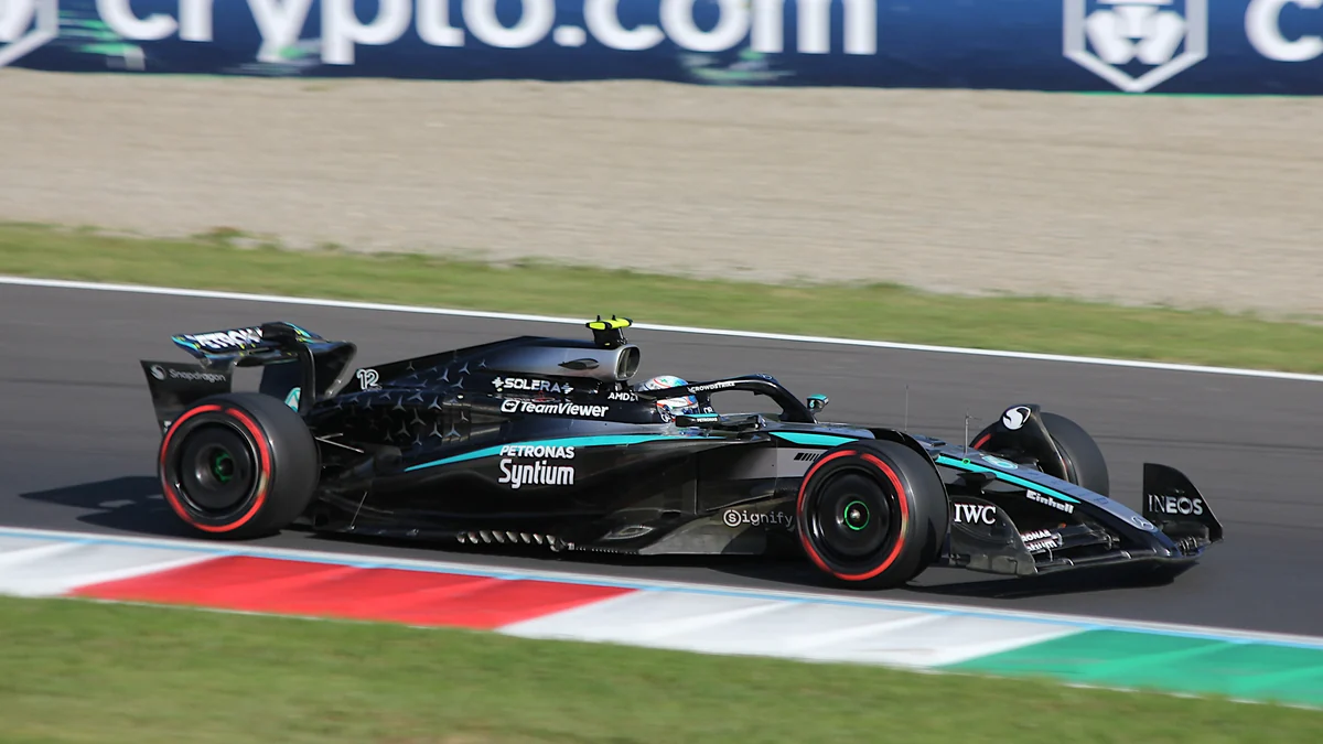 Kimi Antonelli’s black and blue Mercedes runs alongside the track kerb