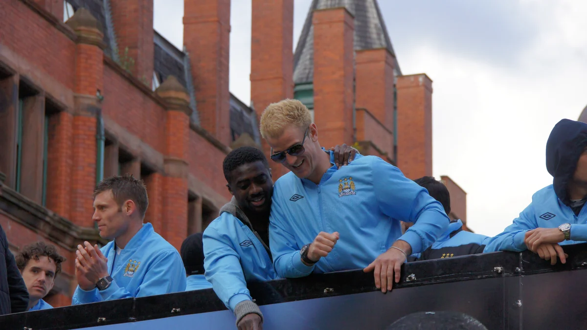 Manchester City players on an open-top bus during a celebration parade
