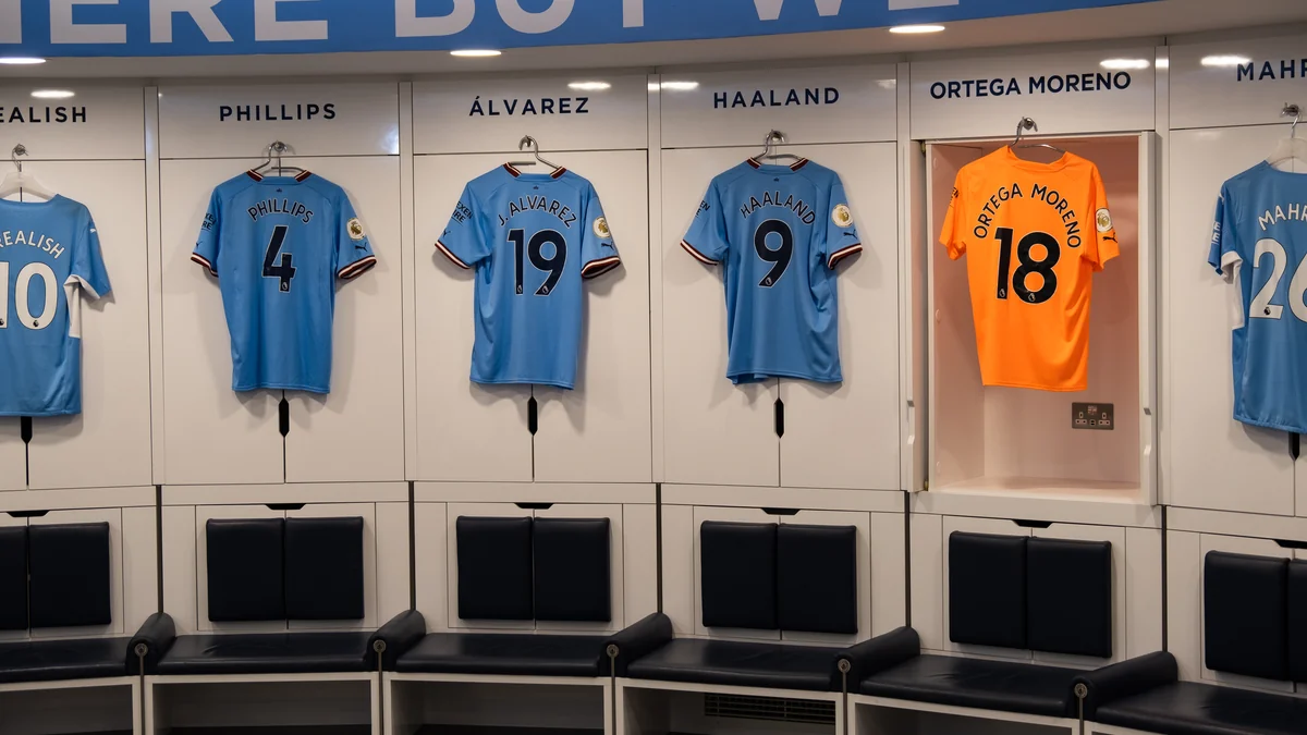 Blue shirts bearing Phillips, Álvarez and Haaland’s names and Ortega’s orange kit in the Manchester City dressing room