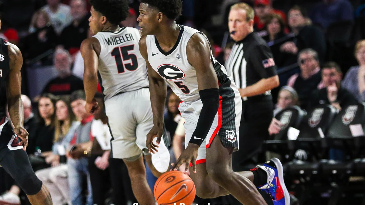 Anthony Edwards in Georgia’s white number 5 uniform dribbling the ball on court