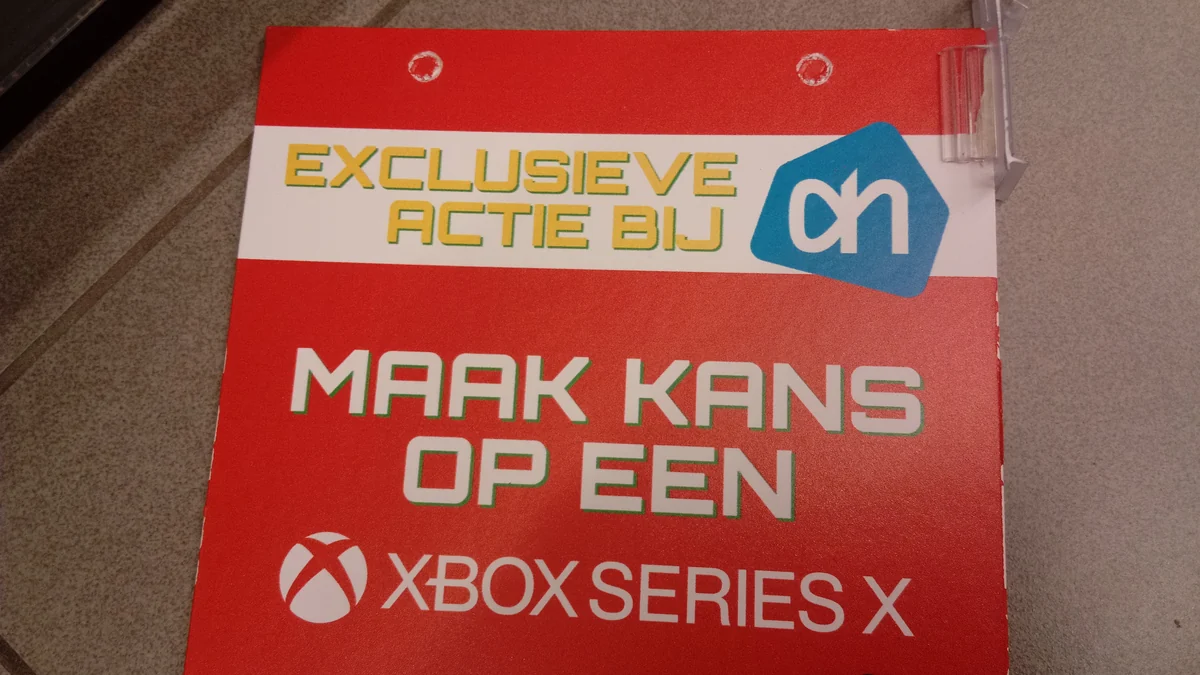 Red promotional sign with the Xbox logo and the words Xbox Series X