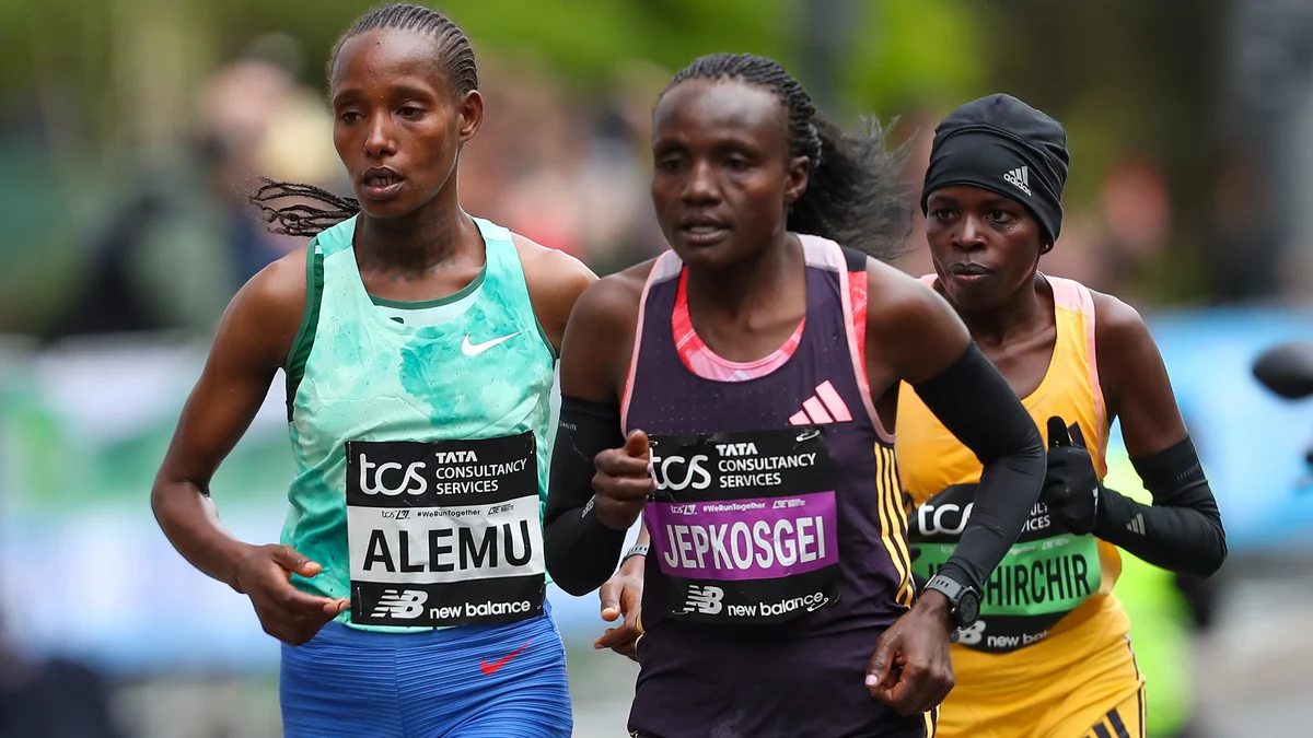 Three elite women runners move together, wearing green, purple and yellow tops, with the third in a black cap.
