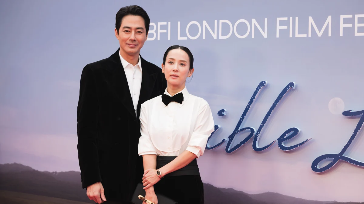 Zo In-sung con traje negro y Cho Yeo-jeong con camisa blanca ante el panel de Possible Love