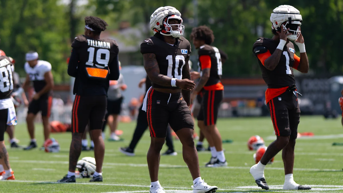 Browns number 10 player standing on the practice field among teammates