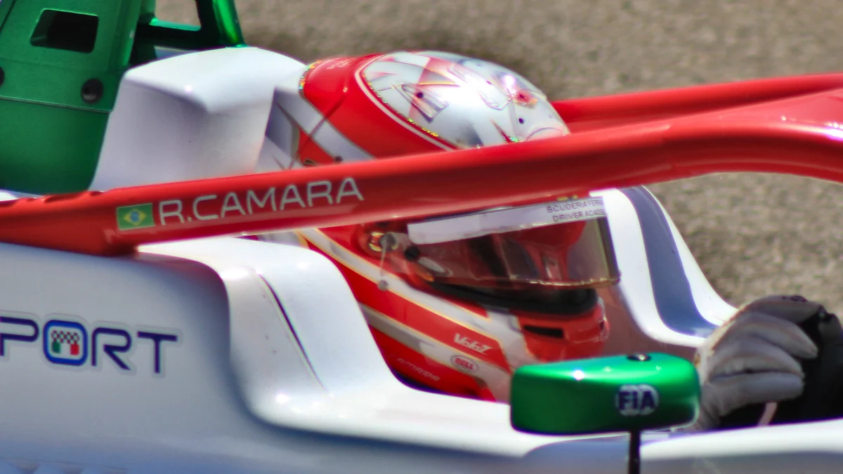 Rafael Câmara wearing a helmet in the cockpit of a Formula Regional car