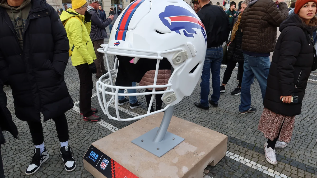 Giant white Buffalo Bills helmet displayed in a square among pedestrians