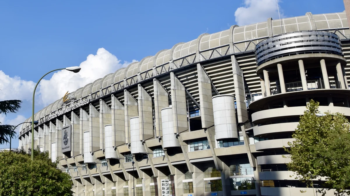 Exterior façade of the Santiago Bernabéu under a blue sky