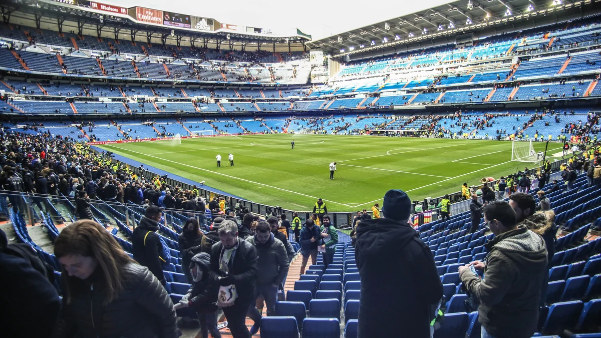 Blue stands and the Santiago Bernabéu pitch viewed from inside the stadium
