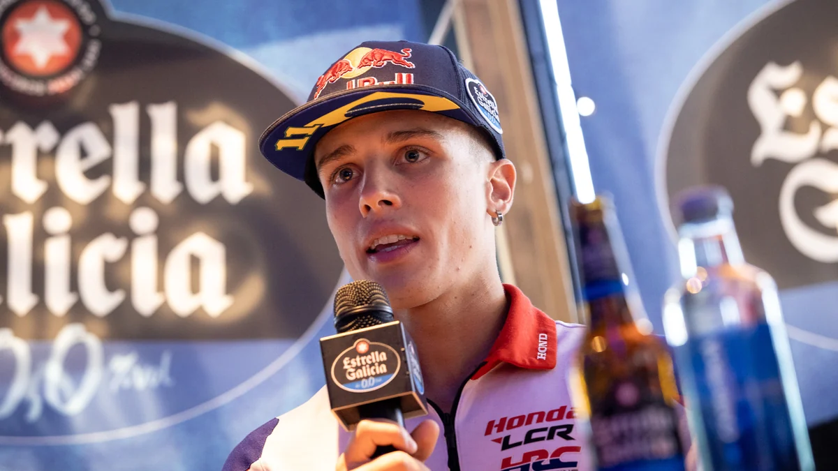 Diogo Moreira speaks into a microphone while wearing a cap and Honda LCR shirt.