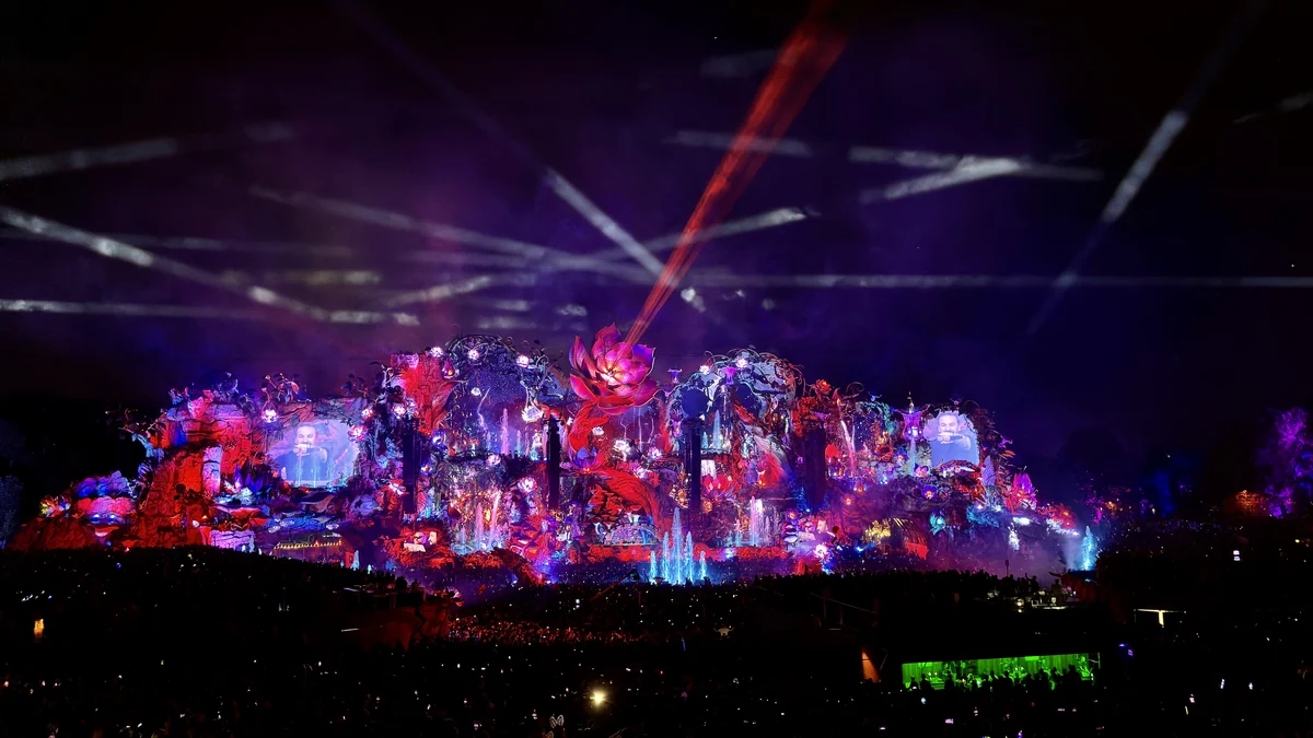 Large stage lit in red, purple and blue during a nighttime festival