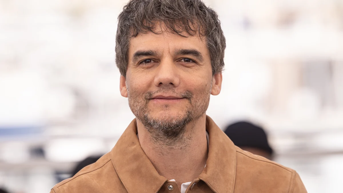 Close portrait of Wagner Moura wearing a brown jacket against a blurred light background