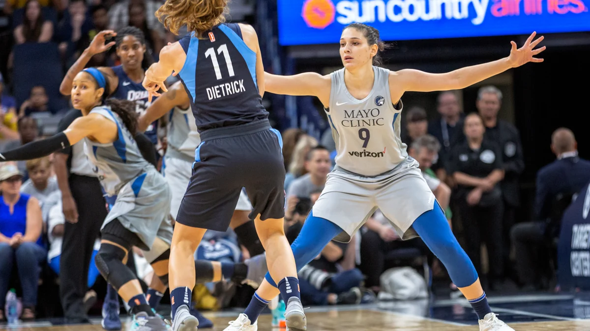 Una jugadora de Minnesota Lynx en posición defensiva frente a una jugadora de Atlanta Dream con el número 11.