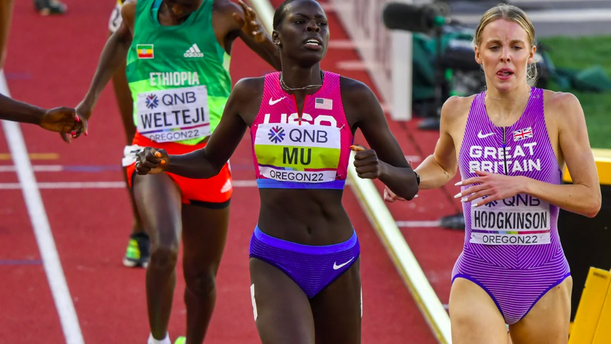 Athletes from the United States, Great Britain and Ethiopia run together on a red track.